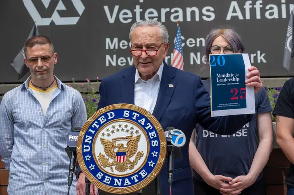 stock image USA, New York, 28 July, 2024: Senate Majority Leader, Chuck Schumer (D-NY) holds photo illustrations on GOP Project 2025 and joined by veterans speaks of danger if Republican candidates will take over White House and Senate at the 2024 election.