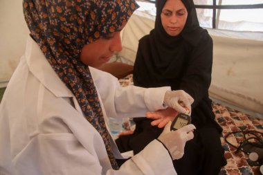 Jenin Abu Zarqa Providing Medical Help to Pregnant Women in Gaza. August 19, 2024, Gaza, Palestine: A 22 years old Palestinian nurse; Jenin Abu Zarqa, who graduated from the nursing school in 2023, opens a medical tent to examine pregnant women clipart