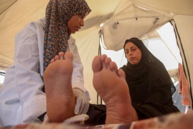 Jenin Abu Zarqa Providing Medical Help to Pregnant Women in Gaza. August 19, 2024, Gaza, Palestine: A 22 years old Palestinian nurse; Jenin Abu Zarqa, who graduated from the nursing school in 2023, opens a medical tent to examine pregnant women clipart