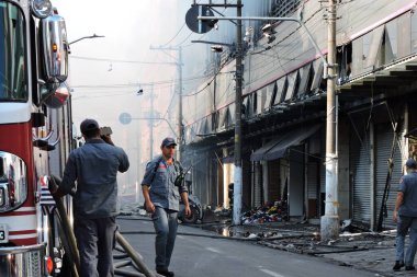 Sao Paulo (SP), Brazil 11/30/2024 - The fire that hit Shopping 25 in Bras, central Sao Paulo, was controlled late Wednesday afternoon. Machines and tractors are removing clothes and products that were not burned.  (leandro chemalle / thenews2) clipart