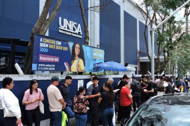 Sao paulo, 10/11/2024 - education/college/enem - gates open at santo amaro university, in the south zone of sao paulo for students arriving to take the second day of tests for the national high school exam - enem 2024 (Leandro Chemalle / thenews2) clipart