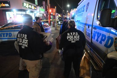 nypd crime scene unit investigators, force investigation division and other officers at the scene of a police involved shooting where police shot an individual in the area of east 80th street and flatlands avenue in the canarsie section clipart