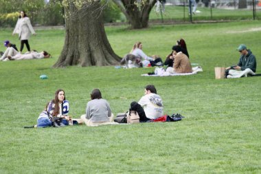 18 Nisan 2025, New York, ABD: New Yorklular New York 'taki Central Park' ın büyük çimlerinde güzel bir cuma gününü kutlarken, spor yaparken, piknik yaparken (niyi fote / the enews2)
