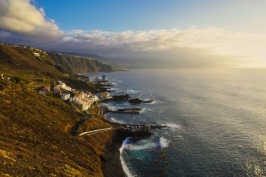 Tenerife 'nin kuzeyinde küçük bir balıkçı köyü olan El Pris yakınlarındaki yaz güneşinin son ışınları