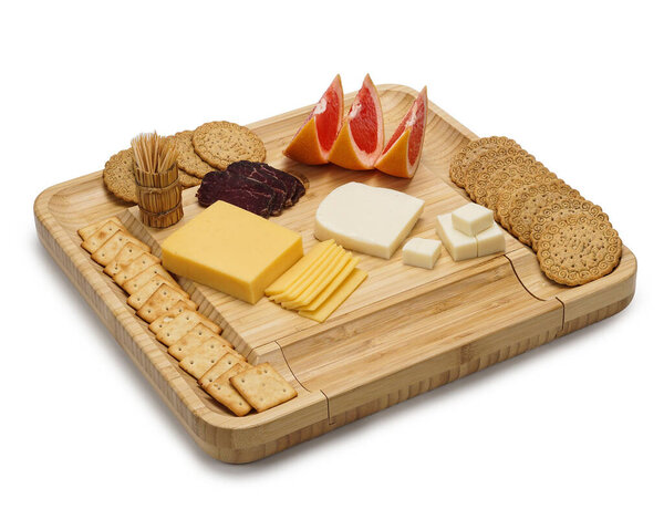 Cheese board with snacks: different varieties of hard and soft cheese with fruits, sweets and meat on a white background