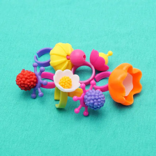 Colorful set of childrens toys, beads, decorations isolated on colorful background.