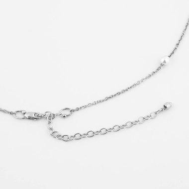 Beyaz arka planda izole edilmiş barok inci kolyeli zarif gümüş bir zincir. Üst görünüm