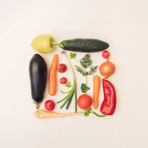 Arranged colorful vegetables in a square on a white background. Flat lay.