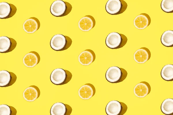stock image Lemon and coconut on a minimal pastel yellow background. Pattern. Modern design.