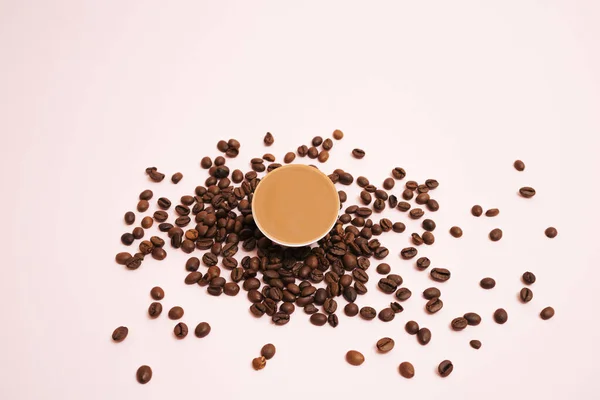Espresso ground coffee capsule with coffee beans.