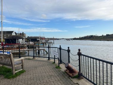 Wivenhoe, Essex East Anglia uk - January 11 2023: Panoramic landscape view of the harbour at  on a Winter day with water boat moorings and cottage buildings  by promenade walk blue sky 