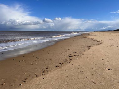 Beautiful sandy beach natural landscape with sand dunes and low sea tide ocean salty stream water under blue sky with cloud in Spring in Winterton Norfolk East Anglia uk   clipart