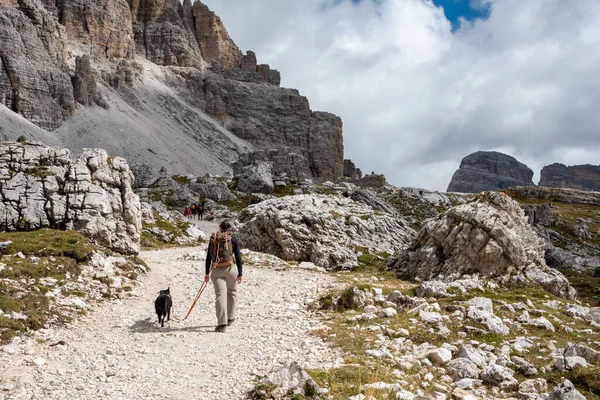 Hiking with a dog around the scenic 3 Zinnen mountains in the Dolomites, South Tyrol