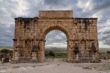 Iconic Triumphal Arch of Volubilis, an old ancient Roman city in Morocco, North Africa clipart