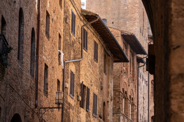 Facade of typical medieval residential houses in downtown San Gimignano, Italy