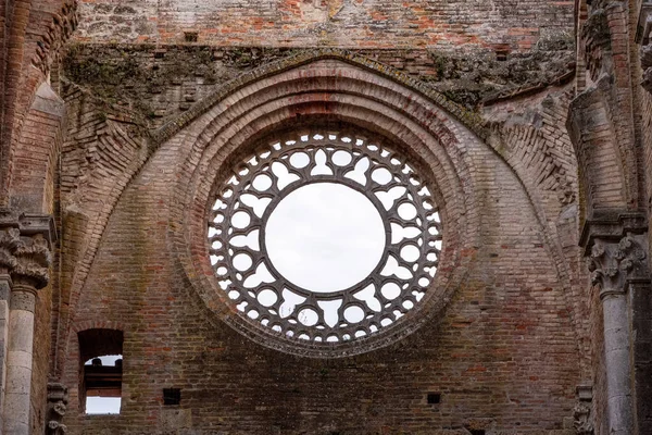 Destroyed window rosette at the abandoned Cistercian monastery San Galgano in the Tuscany, Italy