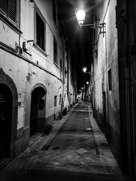 An empty alley in the little village of Montaione in the Tuscany at night, Italy
