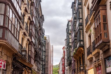 Typical facade of residential buildings with balconies and bay windows in downtown Bilbao, autonomous region of the basque country in Spain