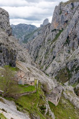 An abandoned ruined farmer house in the picturesque Cares gorge, Picos de Europa mountains in Asturias, Northern Spain clipart