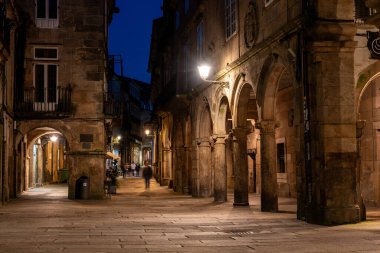 İspanya, Santiago de Compostela 'nın merkezinde eski evleri ve manzaralı geçitleri olan küçük Rua do Vilar Caddesi.