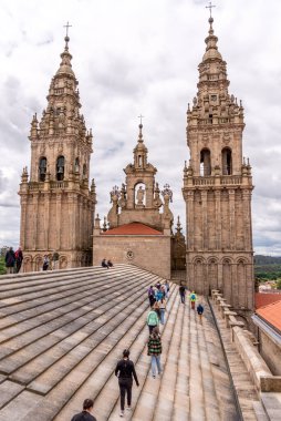 Santiago de Compostela, Spain - Mai 21, 2024 - Tourists walking on the roof of the Santiago de Compostela cathedral towards the southern bell tower, Galicia in Spain clipart