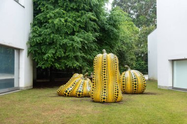 Porto, Portugal - Mai 28, 2024 - Contemporary art sculptures Polka Dots in shape of pumpkins in the park of the Serralves foundation, created by Yayoi Kusama, Porto clipart