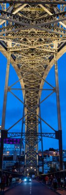 Porto, Portugal - Mai 28, 2024 - Lower level of iconic arched iron bridge Ponte Luis I in the Porto city center at night, Portugal clipart