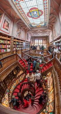 Porto, Portugal - Mai 29, 2024 - Famous curved wooden stairs in the Lello bookstore in Porto, Portugal clipart