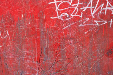 Red concrete wall texture with white scribble marks