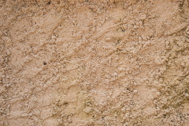 Old and crumbly golden brown concrete wall background texture