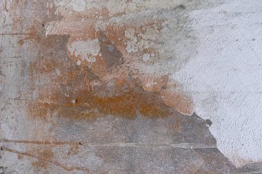 white and rust colored concrete wall with black mildew stains. Grunge background and wallpaper texture
