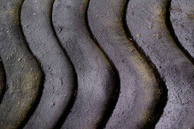 Vertical wave pattern of black concrete stone background texture