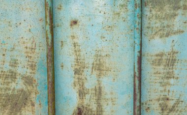 Patina blue and rusted metal panel with two rods. Grunge background texture