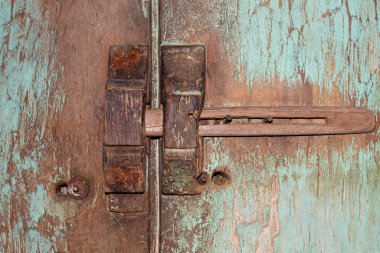 Old and rustic wooden painted and stained doors with sliding wood lock in Bali, Indonesia