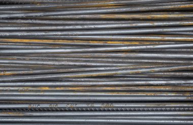 Close up pile of long steel rods with rust. Background texture