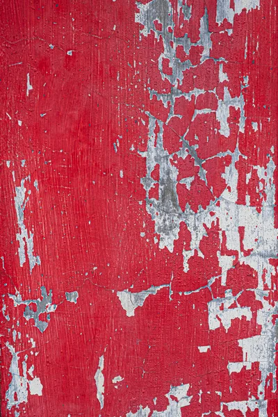 stock image Old red painted and peeling door with scratches. Background grunge texture