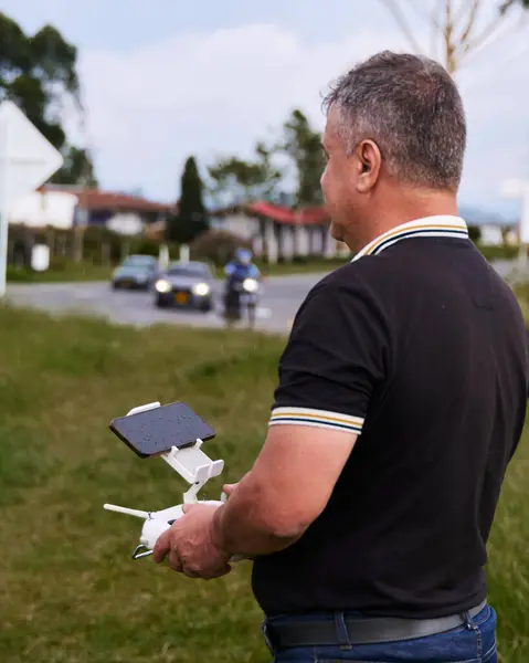 stock image Close-up and side shot of a concentrated man with the control of his drone in hand.