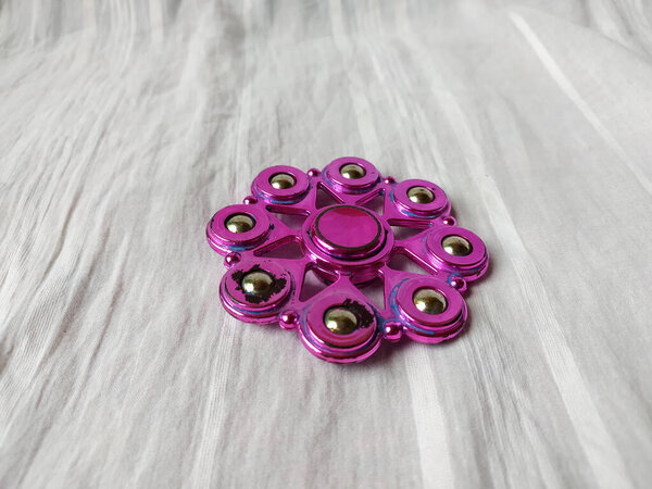 Photo of A toy called spinner is purple in color with a unique shape