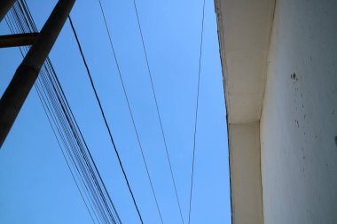 Açık mavi gökyüzü arkaplanlı elektrik hatlarının fotoğraf görünümü