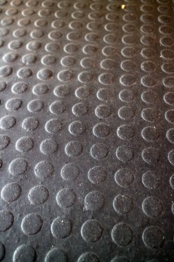 Dairesel desenli desenli desenli siyah kauçuk bir paspasın üzerini kapat.