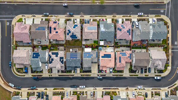 Top Down aerial photos over a community in California with homes with solar panels and roadways and parks