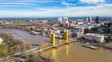 The Tower Bridge in Sacramento, California with the city of of Sacramento in the background and blue sky