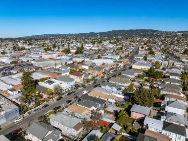 Oakland, California USA January 8, 2025: Aerial image over East Oakland with homes, streets, business and more! clipart