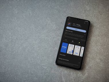 Lod, Israel - July 16,2023: Pango app play store page on smartphone on ceramic stone background. Top view flat lay with copy space.
