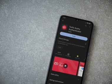 Lod, Israel - July 16,2023: Twilio Authy Authenticator app play store page on smartphone on ceramic stone background. Top view flat lay with copy space.