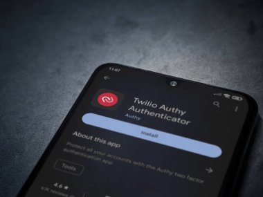 Lod, Israel - July 16,2023: Twilio Authy Authenticator app play store page on smartphone on a dark marble stone background. Top view flat lay with copy space.
