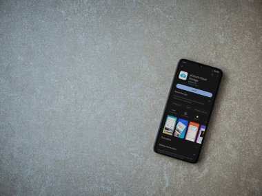 Lod, Israel - July 16,2023: pCloud app play store page on smartphone on ceramic stone background. Top view flat lay with copy space.