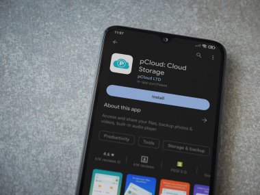 Lod, Israel - July 16,2023: pCloud app play store page on smartphone on ceramic stone background. Top view flat lay with copy space.