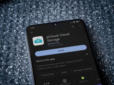 Lod, Israel - July 16,2023: pCloud app play store page on smartphone on a metallic background. Close up top view flat lay.
