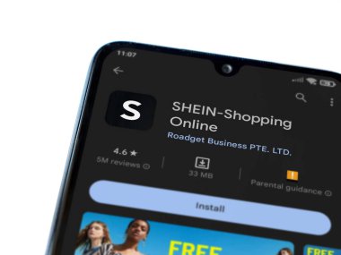 Lod, Israel - July 16,2023: Shein app play store page on smartphone on white background. Top view flat lay with copy space.